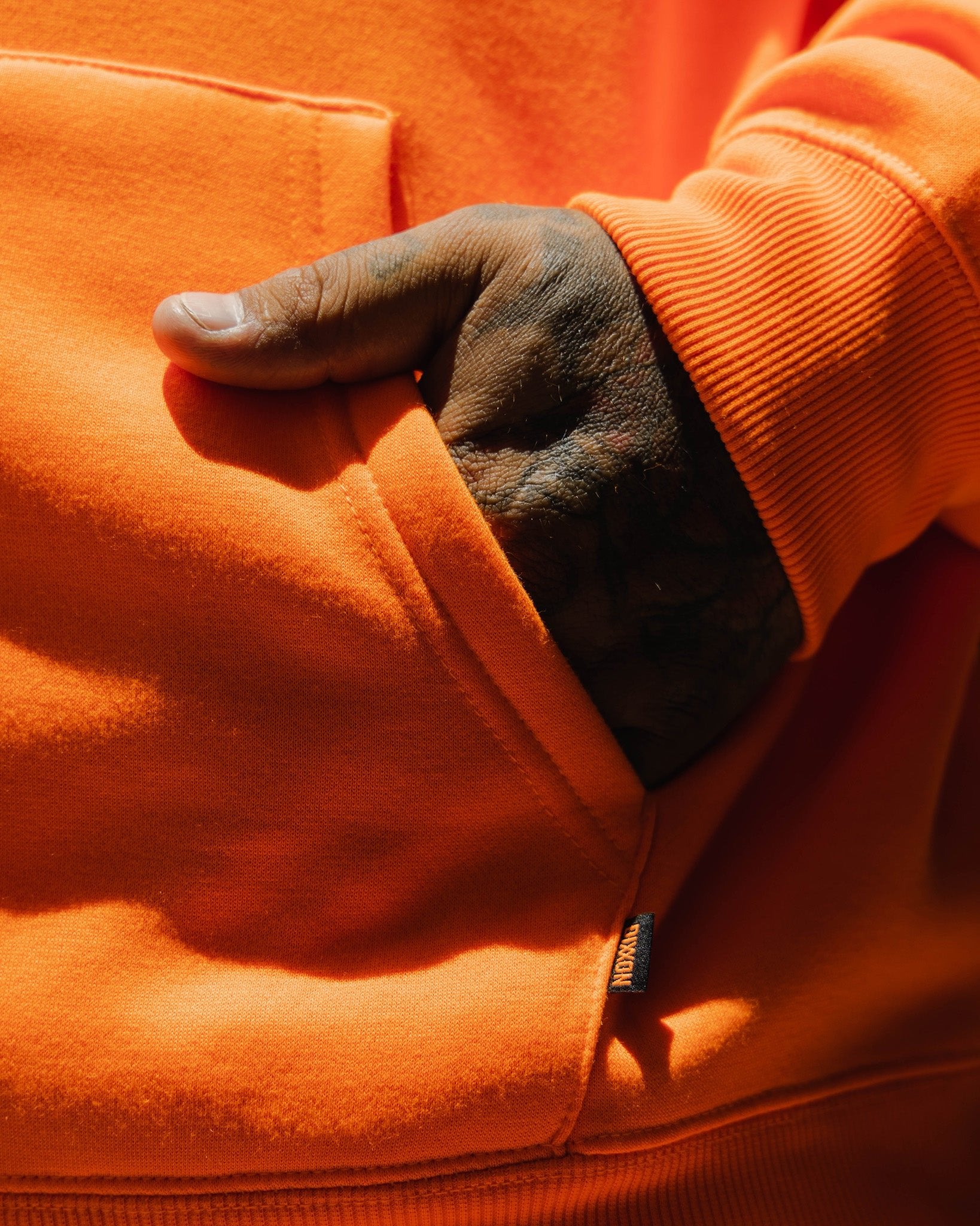 Dixxon Safety Orange Hoodie: Black MFG Badge & Style